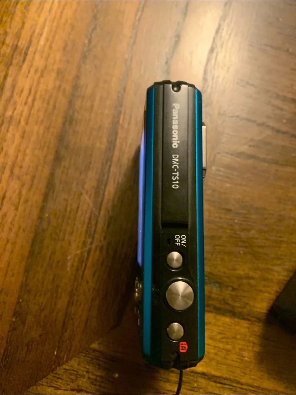 Panasonic Lumix compact camera in bright blue with black charger